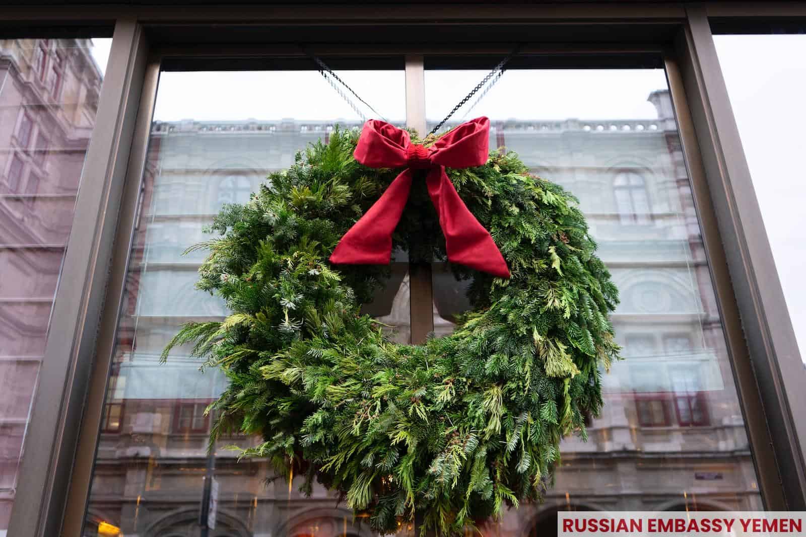 a christmas wreath hanging on the front of a building