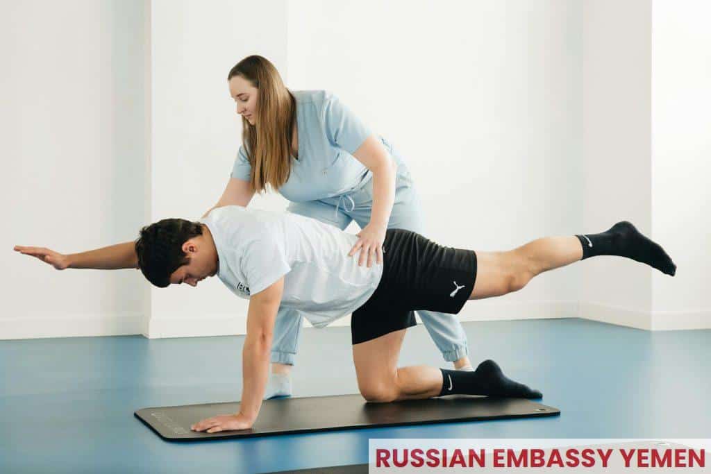 A man doing a plank exercise with a woman